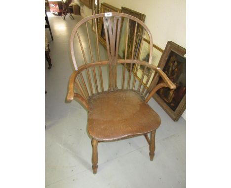 Early 20th Century oak and elm Windsor armchair with stick and splat back, raised on turned supports united by turned h-stret