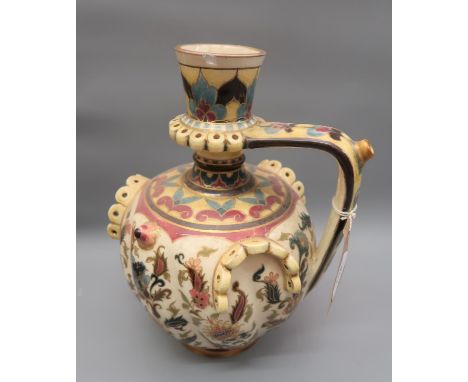 Zsolnay Pecs jug vase with typical floral design on a cream ground (chips to rim and foot rim), 11ins highChip to rim and foo