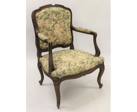 Pair of early 20th Century French open arm chairs with machine woven tapestry covered backs and overstuffed seats on carved c