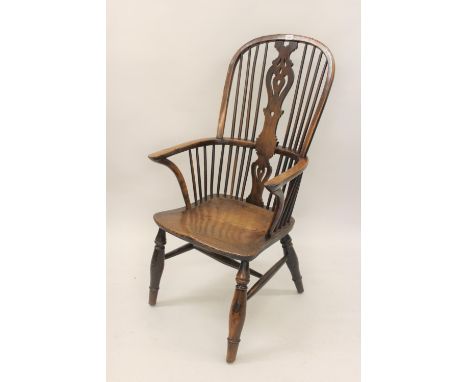 Large 19th Century yew and elm Windsor chair, the high hoop, stick and splat back above a carved panel seat and turned suppor