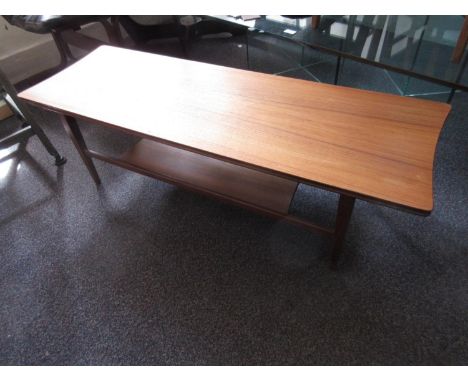 Richard Hornby for Heals, mid 20th Century teak coffee table, the shaped top above tapering supports and undertier, 48ins x 1