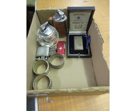 Quantity of various cigarette lighters together with a silver napkin ring and two plated rings 