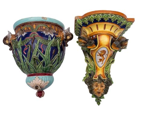 A Pesaro [Molaroni] majolica wall bracket and matched cistern, the former modelled with foliage, mythical dolphins flanking a