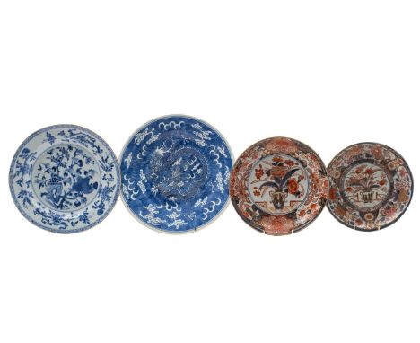 Two Japanese Imari dishes and two Chinese blue and white dishes the first two painted in traditional style with vases of flow