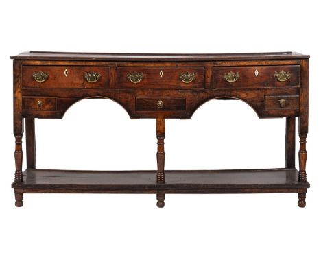 A late 18th-century oak and fruitwood rectangular dresser base; the top with a reeded edge with three short and three small d