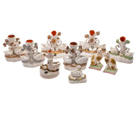 A group of eight Staffordshire swan inkwells and spill vases together with a pair of models of cats, late 19th/20th century  