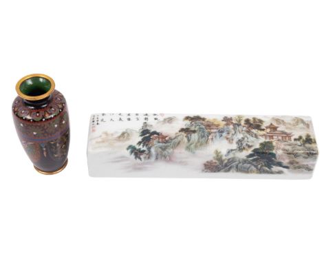 A Chinese porcelain scroll weight and a small Japanese cloisonne vase the weight decorated with pavilions in a mountainous la