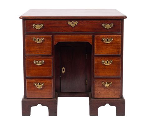 A George III mahogany kneehole desk, the rectangular top with rounded corners and a moulded edge, fitted with a single long f