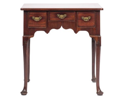 A George II mahogany lowboy, first half of the 18th century, the rounded top above three frieze drawers with swan neck brass 