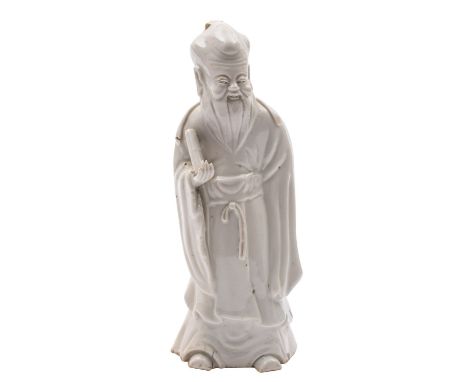 A Chinese blanc-de-chine figure of Shou-Lao wearing flowing robes and holding a scroll, Qing dynasty, 24cm [minor damage].