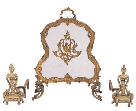 A French gilt brass cartouche shaped fire screen; the foliate and scroll decorated frame with carrying handle and central car