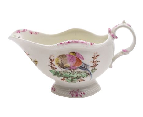 A First Period Worcester polychrome sauce boat with double scroll handle and shaped oval pedestal foot, painted with exotic b