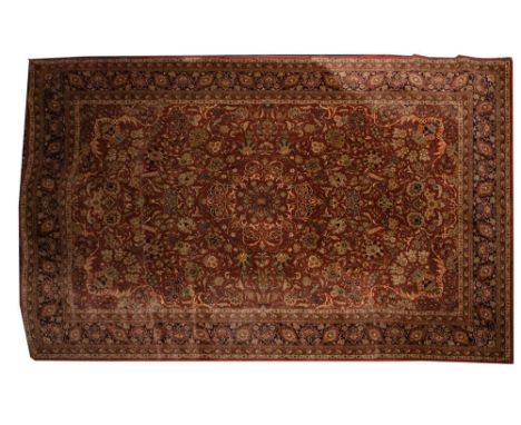 A Louis de Poortere carpet of Kashgai design, machine made, the light brown field with a central medallion and all over scrol