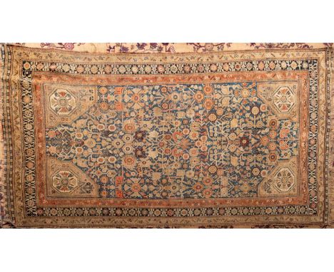 A Melayer rug, the shaded powder blue field with all over geometric floral foliate designs, light brown spandrels and enclose