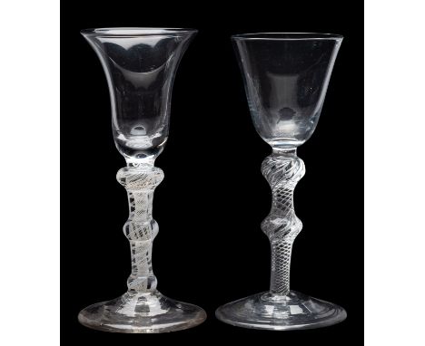 Two wine glasses, the first with bell shaped bowl set on a tapering double knopped, double series opaque twist stem and conic