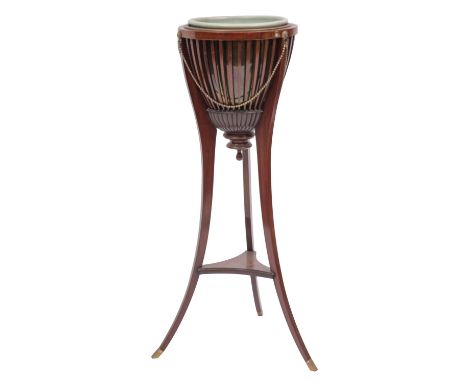 An Edwardian mahogany brazier type jardiniere stand; the slatted urn with brass and ceramic liners, hung with brass lion mask