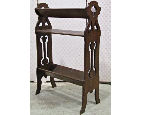 An Arts &amp; Crafts style floorstanding bookstand/trough with pierced ends and swept supports, 56 cm long x 85 cm high 