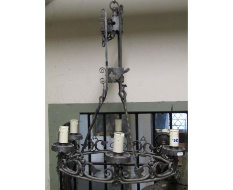 A good quality antique style cast metal hanging ceiling light in the gothic style with pierced scrolling detail, circular rin