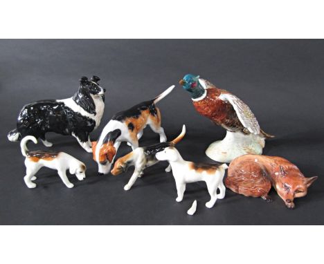 A collection of Beswick wares including a pheasant in flight number 850, a black and white collie, a recumbent fox and three 