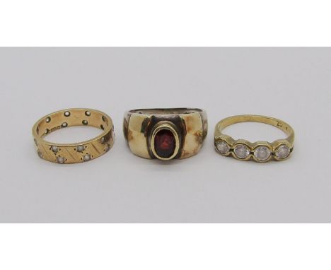 Two 9ct rings set with white stones, 4.6g total, together with a further silver ring set with a garnet (3) 
