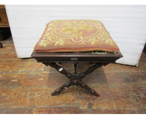 A mid-19th century mahogany centre stool raised on turned egg shaped supports united by a central rail, with later hand worke