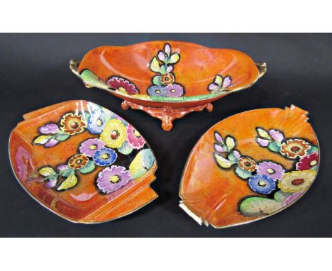 A collection of Carltonware art deco lustre wares in the Hollyhocks pattern on an orange ground comprising a two handled oval