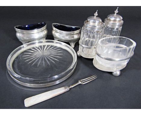 A silver condiments set, London 1886, two silver salts, a silver rimmed coaster and a small fork (5) 
