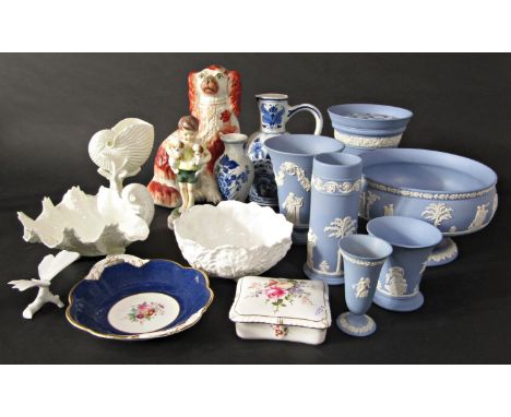 A collection of Wedgwood blue ground Jasperwares comprising a vase with flower holder, 17.5cm tall approx, four further vases