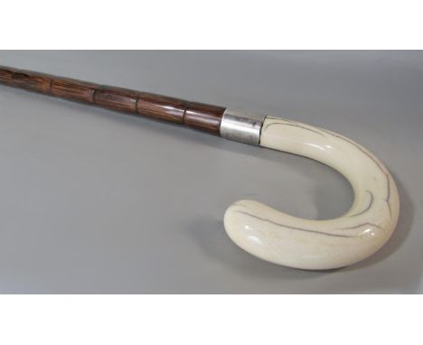 An ivory handled bamboo walking stick bearing a dedication to "Rev A. Mallinson" to the silver collar 