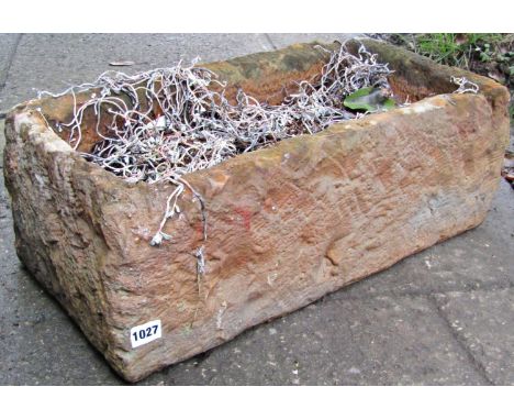 A rectangular garden planter in the form of a mock rough hewn stone trough (composite material), 60 cm long x 30 cm wide x 20