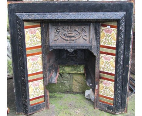 Three reclaimed cast iron fire inserts/grates, varying design, one enclosing floral printed ceramic tiles, (AF) 
