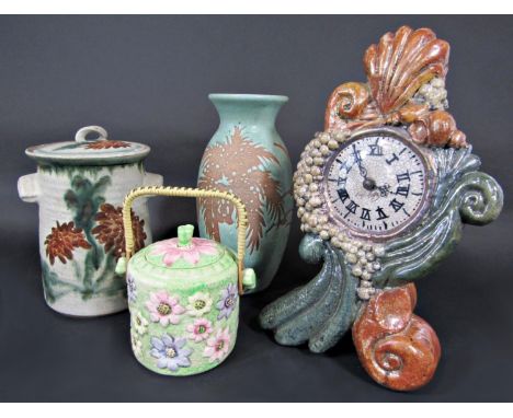 An unusual studio pottery mantel clock with painted and crackle glaze finish containing a quartz movement, the face signed Ha