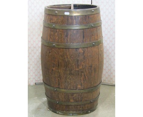 An oval coopered oak and brass banded barrel shaped stick stand, 68cm high 