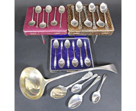 A Georgian shield shaped silver spoon, a boxed set of silver teaspoons with blue enamelled nurses to the handles, two further