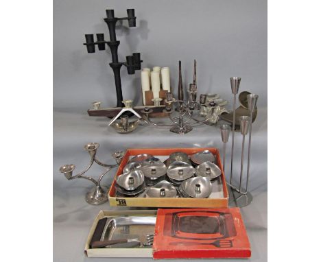 A large collection of stainless steel retro Danish candelabra and candlesticks, a wooden block with six vodka shot tubes, a b