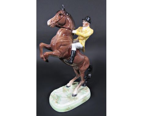 A Beswick model of a rearing horse with yellow jacketed huntsman for the Berkeley Hunt, impressed number to base 868 (af) 