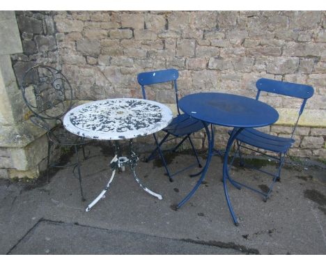 A cast aluminium garden terrace table with circular pierced top raised on swept supports, with layers of painted finish, toge