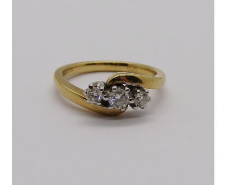 18ct three stone diamond crossover ring, 0.25cts total, size L, 3.9g 