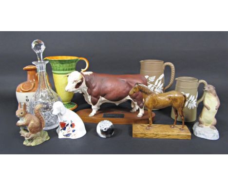 A Beswick Connoisseur model of a Hereford bull raised on an oval wooden base, together with an Aynsley model of a red squirre