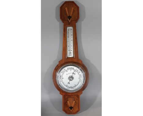 An art deco aneroid barometer in walnut and figured walnut, with decorative applied detail and enamelled bezel 