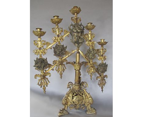 A 19th century portable brass altar candelabra with adjustable arms and height