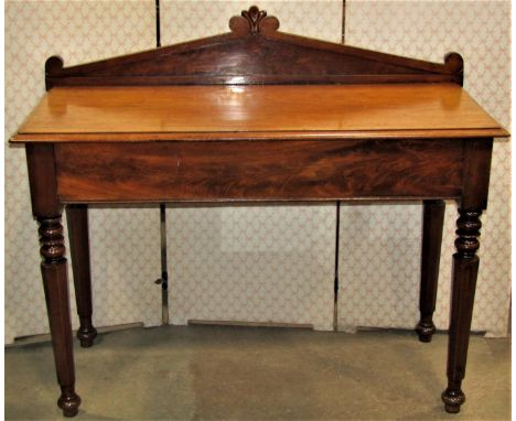 A Victorian mahogany hall table, the raised scrolled architectural back over a frieze drawer raised on turned and tapered oct