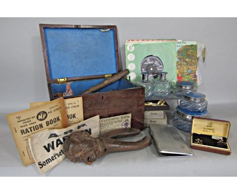 A miscellaneous collection of items including a nutcracker in the form of a moustache old man, a blue dressing table set, col
