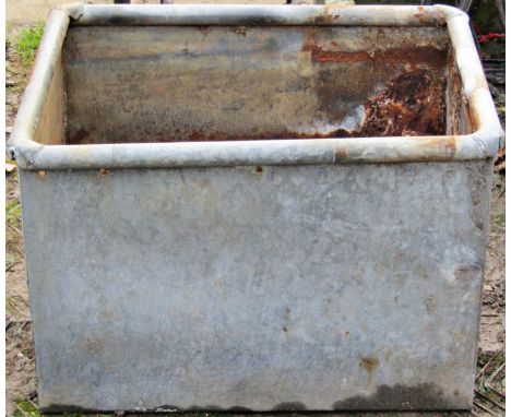 A galvanised steel tank/trough of rectangular form with tubular rim, 64 cm long x 50 cm wide x 43 cm high, together with an i