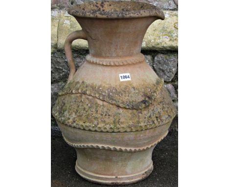 A weathered clay pitcher with drawn neck, moulded loop handle and thumb pressed banded detail, 50 cm high 