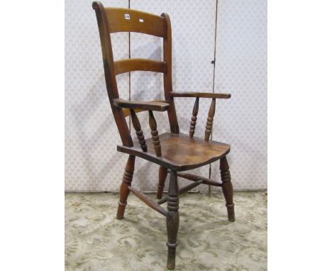 A Windsor stained elm and beechwood triple bar back armchair with saddle shaped seat raised on ring turned and tapered suppor