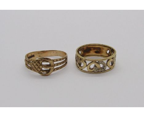 Two 9ct rings; a buckle ring and an openwork heart design ring set with diamonds, 4.9g total (both slightly misshapen) (2) 