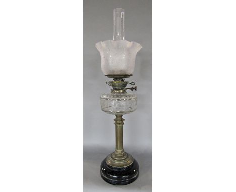 A Young's oil lamp, classical brass column stand with a clear font, floral flared shade, 68 cm high 