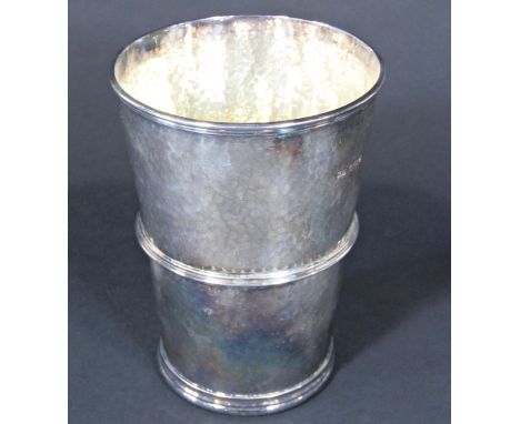 A silver hammered finish beaker, Sheffield 1921, Atkin Brothers, 13 cm tall, and a silver hip flask 17 oz approximately (2)