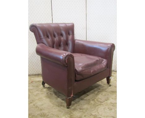 An Early 20th century button back drawing room chair with rolled arms and back, brown leather upholstery, with loose seat cus